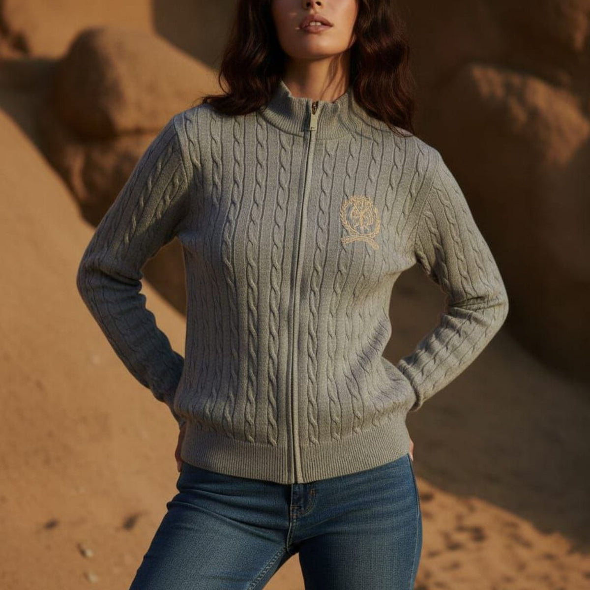 Gray cable knit zip-up cardigan styled with jeans