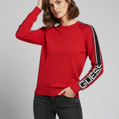 Model wearing red Guess knit crewneck sweater