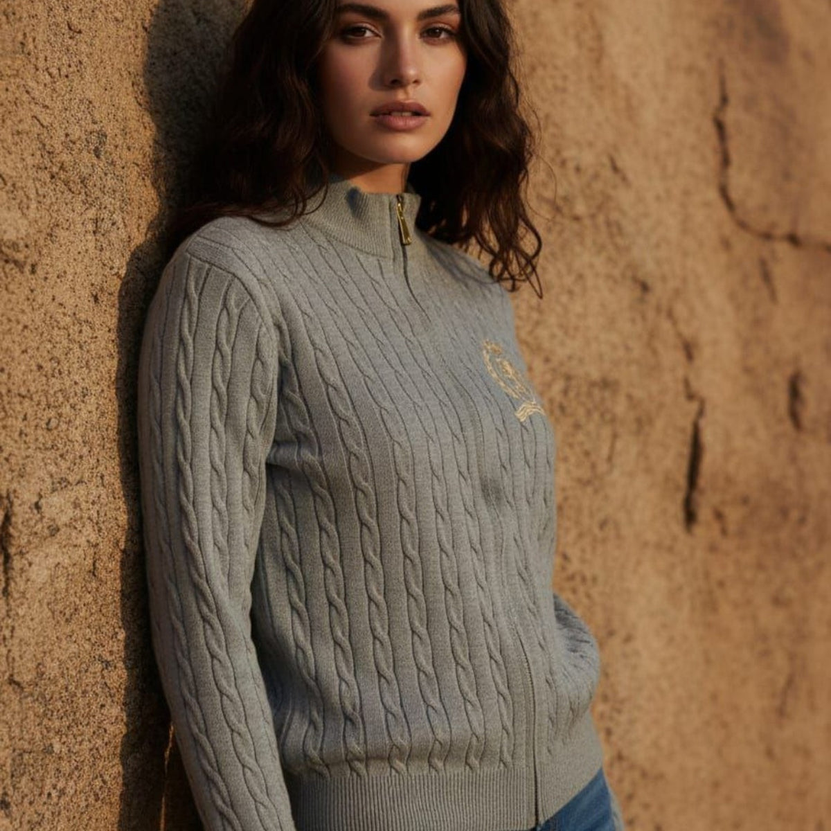 Gray cable knit zip-up cardigan with crest detail