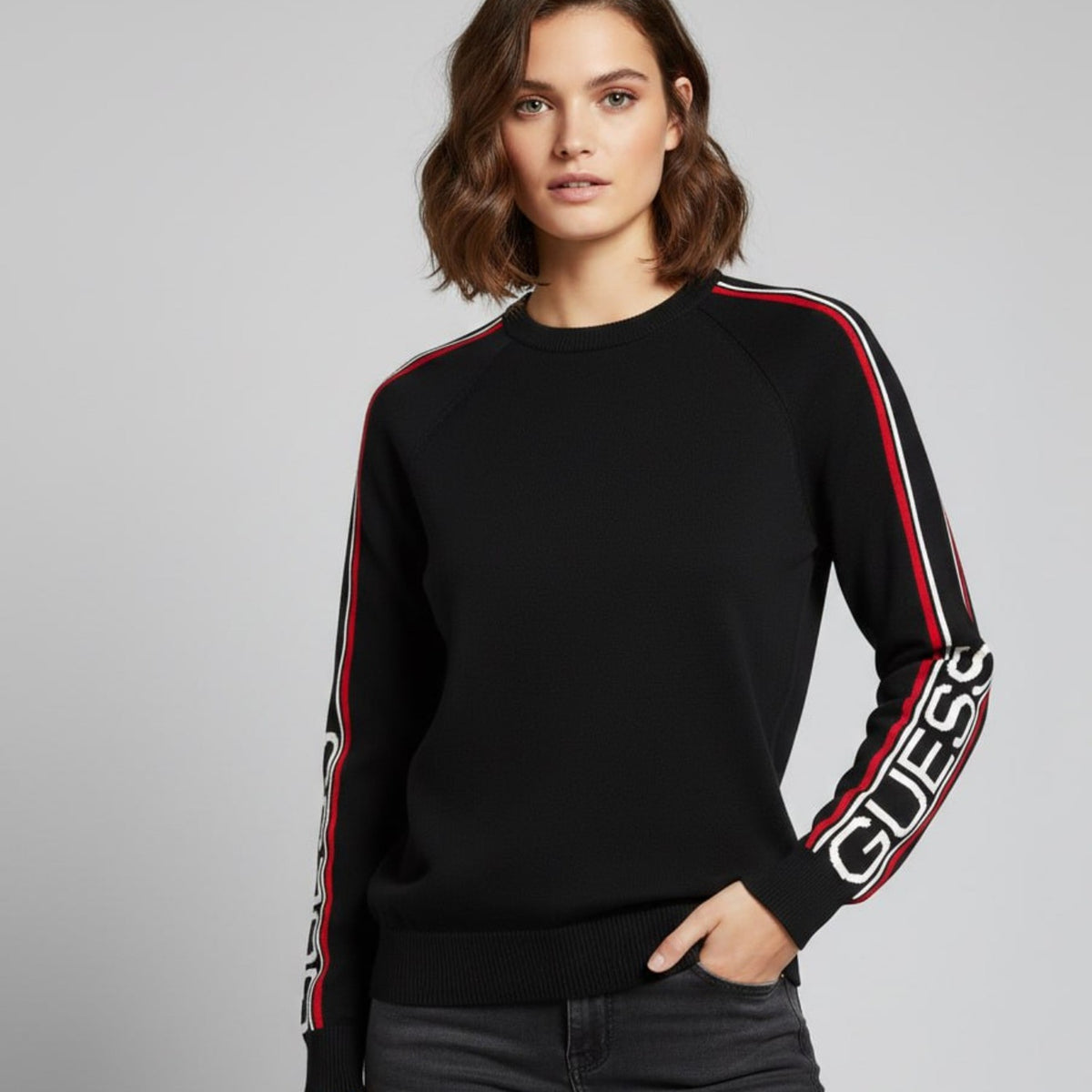 Model wearing black Guess knit crewneck sweater
